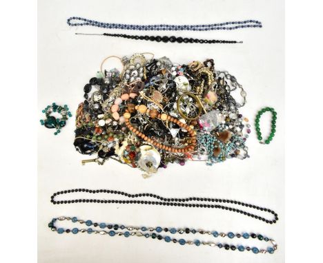 A mixed group of costume jewellery including bead necklaces, brooches, bangle, etc.