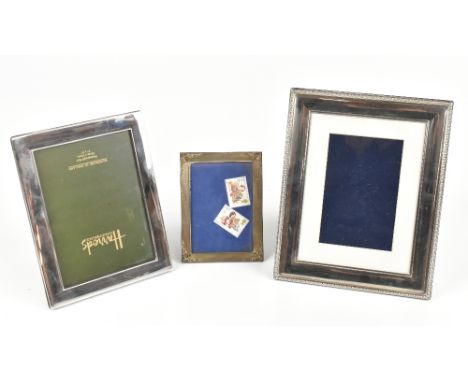 An imported 925 silver photograph frame with engine turned and chased detail to the corners, marks rubbed, 10 x 12cm, also a 