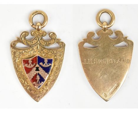 A 9ct yellow gold, red and blue enamel decorated shield shaped fob inscribed 'J.H. Shortland', length including ring loop 4cm