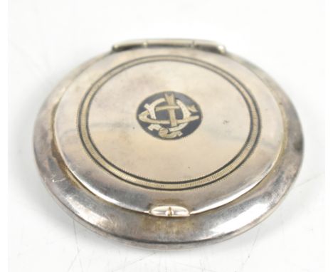 An Iraqi white metal compact of circular form with niello detail verso, the hinged cover enclosing a mirrored panel, diameter