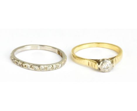 A yellow metal single stone diamond solitaire ring, size Q, and a white metal half eternity ring, size Q 1/2, combined approx