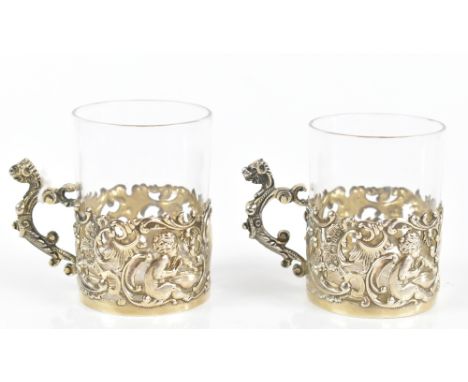 WILLIAM COMYNS; a pair of Victorian hallmarked silver mounted coffee cans, with pierced cast detail, depicting cherubs, and s