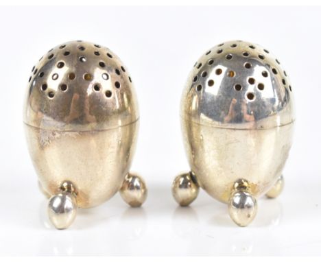 RICHARD SIBLEY I; a pair of Victorian hallmarked silver novelty pepperettes modelled in the form of eggs raised on three feet