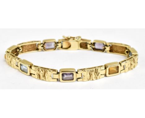 A 14ct yellow gold bracelet with textured panels of gold interspersed by coloured stones, length 17.5cm, approx 20.5g.Additio