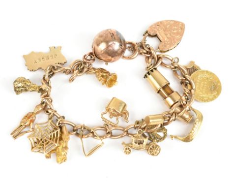 A 9ct yellow gold charm bracelet with a series of charms including miner's lamp, frog, spiders web and folding orb, approx 46