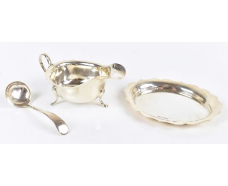 VINER'S LTD; a George VI hallmarked silver sauce boat, ladle and stand, the sauce boat and stand with pie crust edge, Sheffie