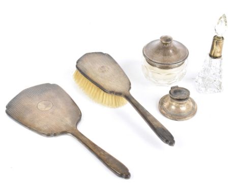 ADIE BROS LTD; an Elizabeth II hallmarked silver two-piece dressing table set, comprising hand mirror and hair brush, each wi