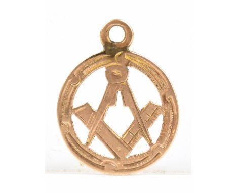 MASONIC INTEREST; a small 9ct yellow gold pierced pendant set with protractor and dividers, diameter approx 12mm, approx 0.6g