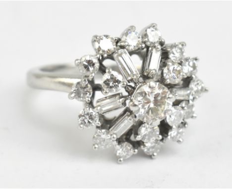 A platinum diamond cluster ring set with brilliant and baguette cut stones, the central diamond weighing approx 0.50cts, size