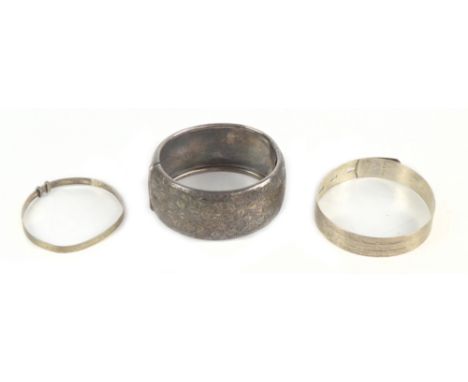Three cuff bangles, including a Charles Horner silver example with engine turned decoration (3).