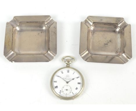 DEAKIN &amp; FRANCIS; a pair of Elizabeth II hallmarked silver ashtrays of square form, one with presentation inscription dat