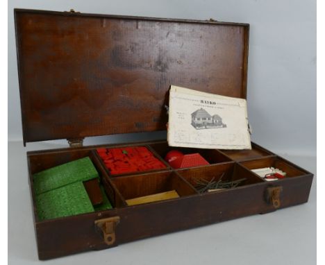 A quantity of Bayko construction pieces and accessories, in scratch-built wooden box with building plans, 58cm long