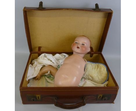 An Armand Marseille bisque head baby doll (dismantled), with moulded hair, sleeping eyes, open mouth with teeth and compositi