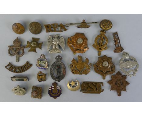 Over twenty military badges, including WW2 tank corps, South Staffordshire regiment, Medical Corps, East Yorkshire regiment, 