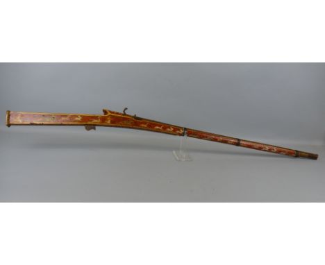 An Indian matchlock hunting musket, the 90cm steel tapering barrel with ram rod under, the wooden stock painted all over with