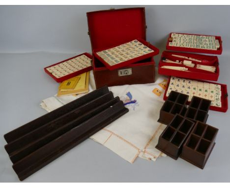 A Chinese Mah-jongg set, with bone and bamboo tiles and sticks in leather carrying case with five lift-out baise lined trays 