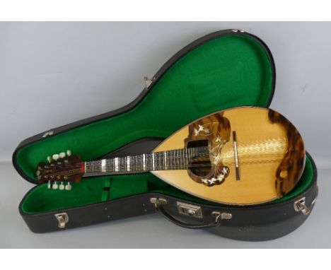 An Italian lute back mandolin, third quarter of the 20th century, with banded rosewood back and neck and sprucewood top, bear