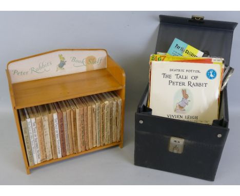 Peter Rabbit's Book Shelf - a beech table top bookcase containing twenty-two Peter Rabbit books, various ages and conditions 