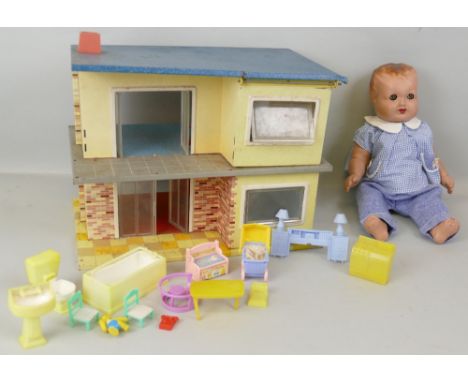 A Mettoy tin-plate contemporary style doll's house, with hinged flat roof, two ground floor rooms and staircase to open plan 