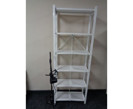 A contemporary metal folding bookshelf and a floor lamp 