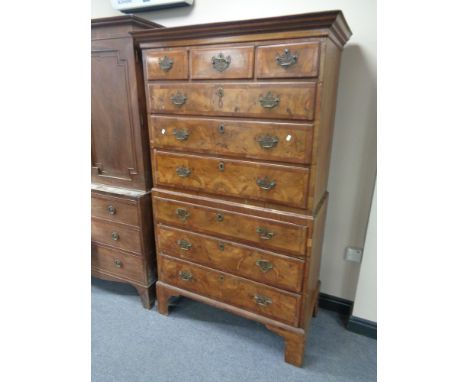 A George II walnut nine drawer chest on chest with brass drop handles on bracket feet  CONDITION REPORT: 178cm high by 102cm 
