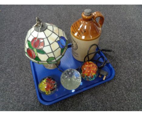 A tray of three glass paperweights, Tiffany style lamp with shade, glazed pottery Fentimans flagon 