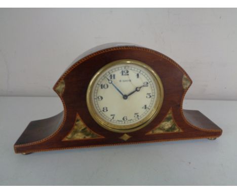 An early twentieth century inlaid Swiss mantel clock on brass feet 