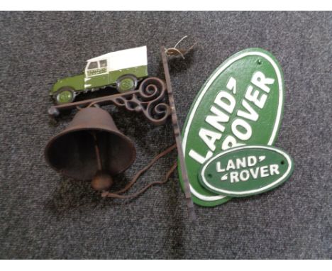 A cast iron Land Rover wall bracket with bell and cast iron Land Rover plaques 