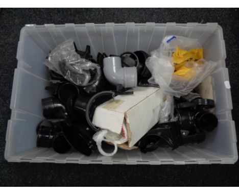 A box of plastic drain pipe fittings 