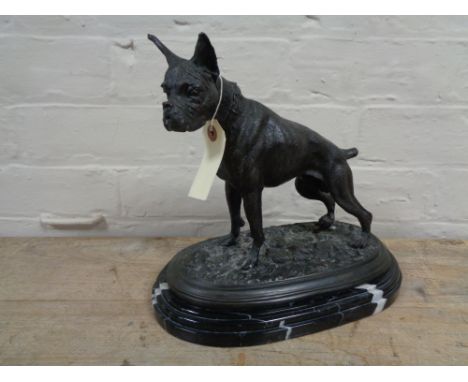 A bronze figure of a Boxer dog on black marble base