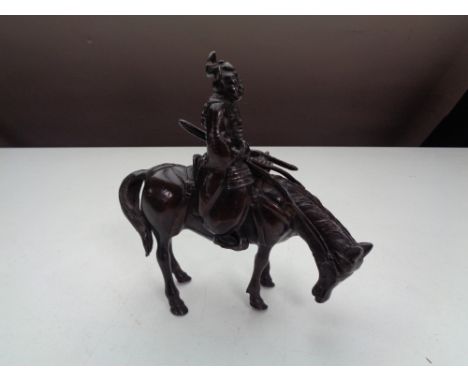 A bronze figure of a Japanese Samurai on horse back 