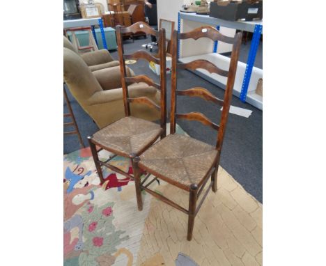 A pair of antique ladder back country kitchen chairs 