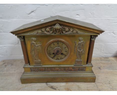 An antique brass cased mantel clock with figural decoration 