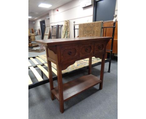 A contemporary console table fitted with three drawers 