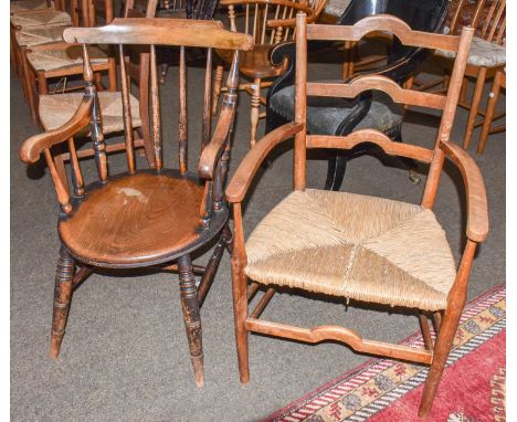 A early 20th century rush seated ladder back armchair, and a spindle back Windsor armchair