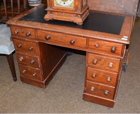 A late Victorian mahogany kneehole desk with leather inset panel and moving on casters, 103cm by 61cm by 72cm 