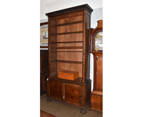 An 18th century style oak open bookcase, the base with cupboard doors, raised upon bun-shaped feet, 247cm by 122cmCondition r