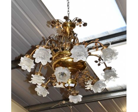 An ornate gilt metal and brass twelve branch chandelier, the glass shades carved as flowerheadsCondition report: Dimensions 8