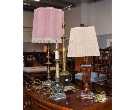 A pair of brass table lamps; together with another shaped as a fluted column raised on a plinth, with two others and a furthe