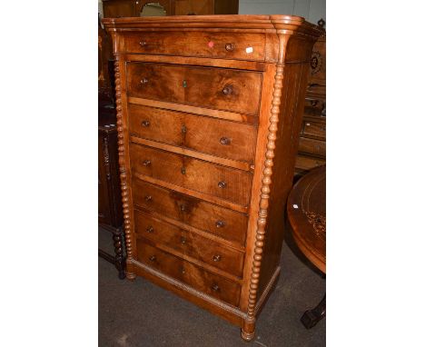 A 19th century Continental walnut wellington chest, with bobbin turned supports, 91cm by 48cm by 149cm