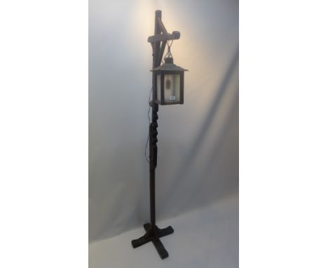 A 20th Century carved wooden standard lamp in the form of a street lantern