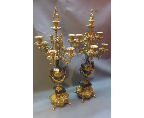 A Pair of Continental six light candelabra, the scrolling arms raised on black marble and ormolu mounted urn support flanked 