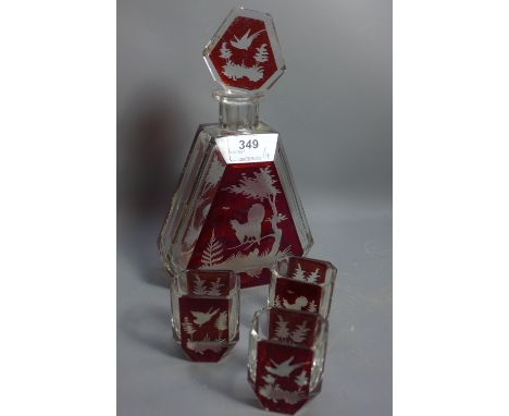 A 1940's Czech glass decanter with acid etched panels depicting a stag together with three matching glasses.  