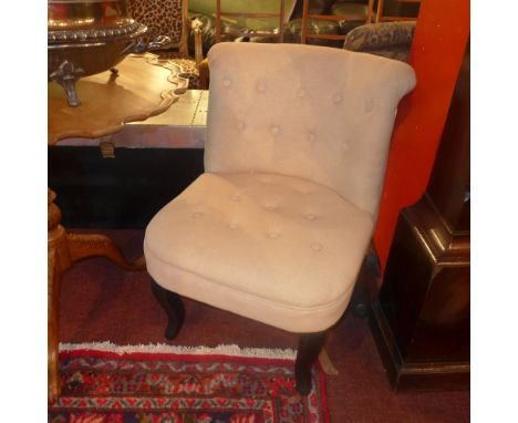 A pair of contemporary bedroom chairs with button back stone linen upholstery raised on ebonised sabre legs