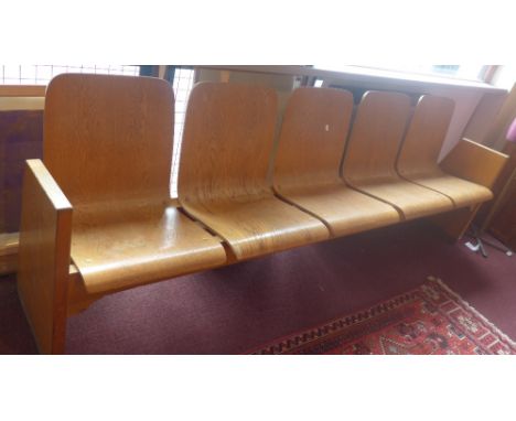 A mid 20th Century oak five seater bench. H-83cm W-250cm D-45cm