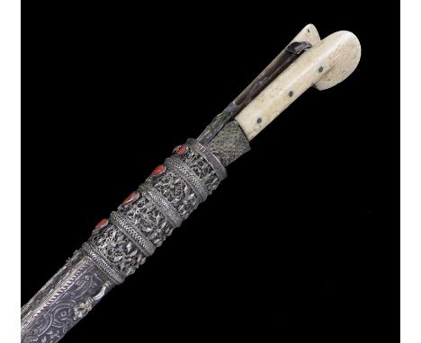 19th Century Ottoman Yataghan, with a silvered and coral scabbard to the walrus ivory grip and steel blade, 50cm long