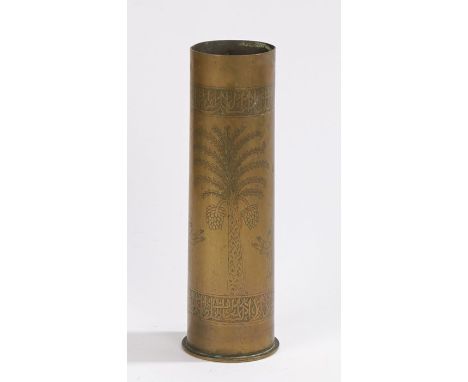 First World War trench art in the form of a German 77mm field gun shell case with an engraved frieze top and bottom framing a