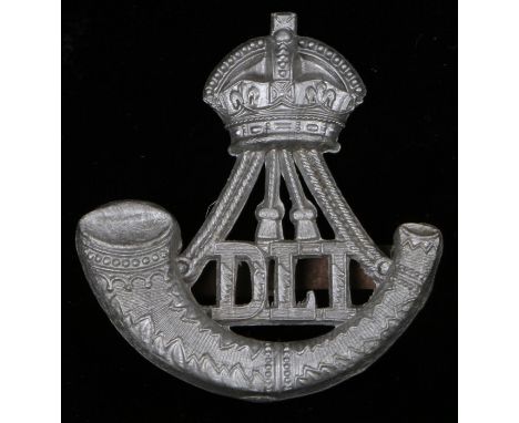 World War Two plastic economy cap badge to the Durham Light Infantry, in silver grey, two blades to the reverse, K&amp;K 2256