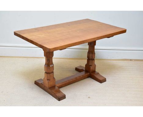 WORKSHOP OF ROBERT MOUSEMAN THOMPSON; an adzed oak refectory dining table, on octagonal columns united on a stretcher, length