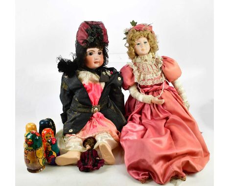 A collection of vintage and modern bisque headed dolls, Continental porcelain and ceramic model of a girl wearing a bonnet ha